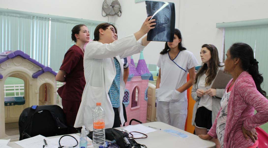 Projects Abroad Medicine interns examine an X-Ray that a local doctor is holding during their Medical Internship in Mexico. Medical interns on their Medicine internships in Mexico examine an X-Ray with a local doctor explaining what they see.
